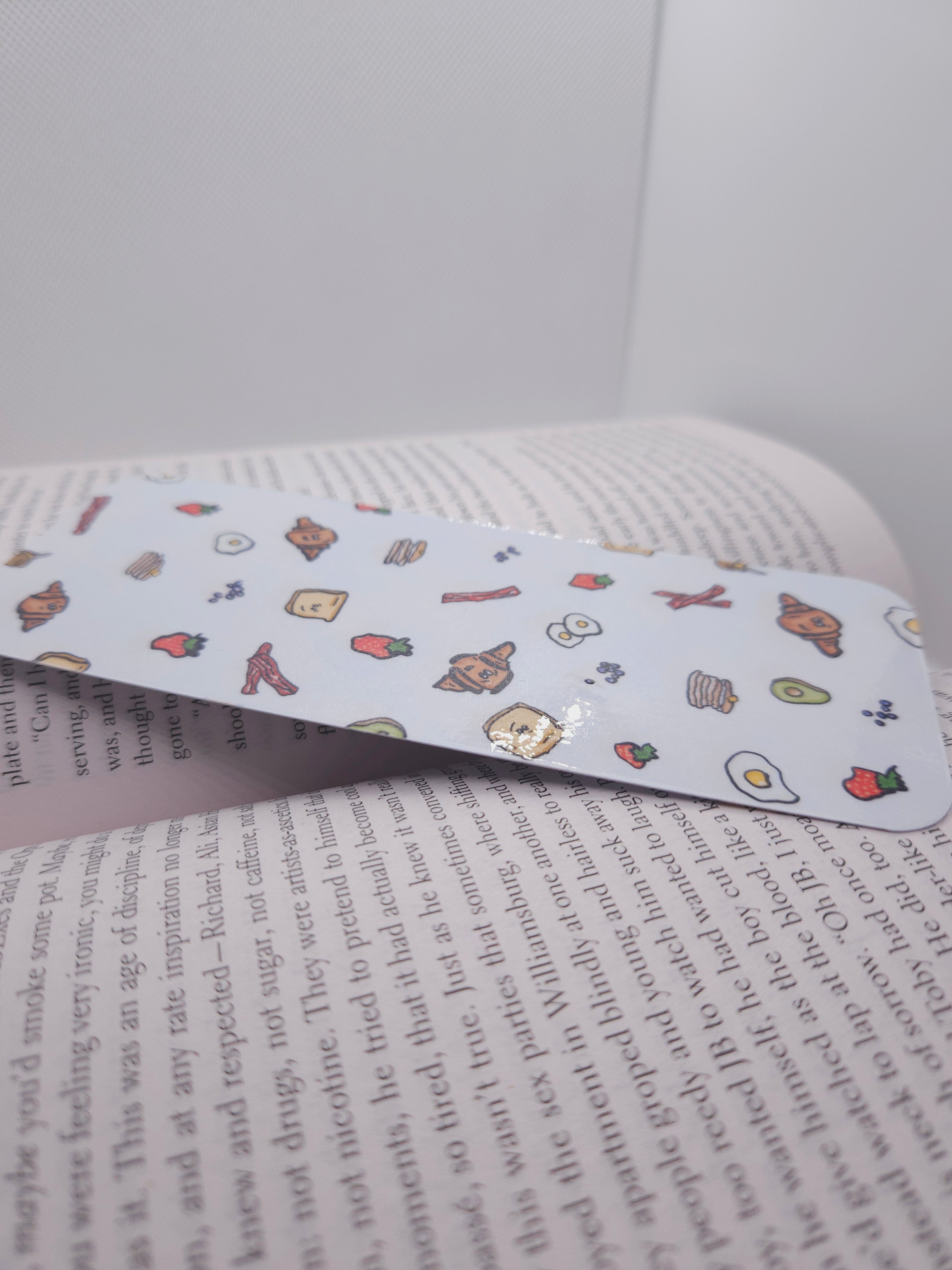 Book with a bookmark featuring cartoon characters on a white background