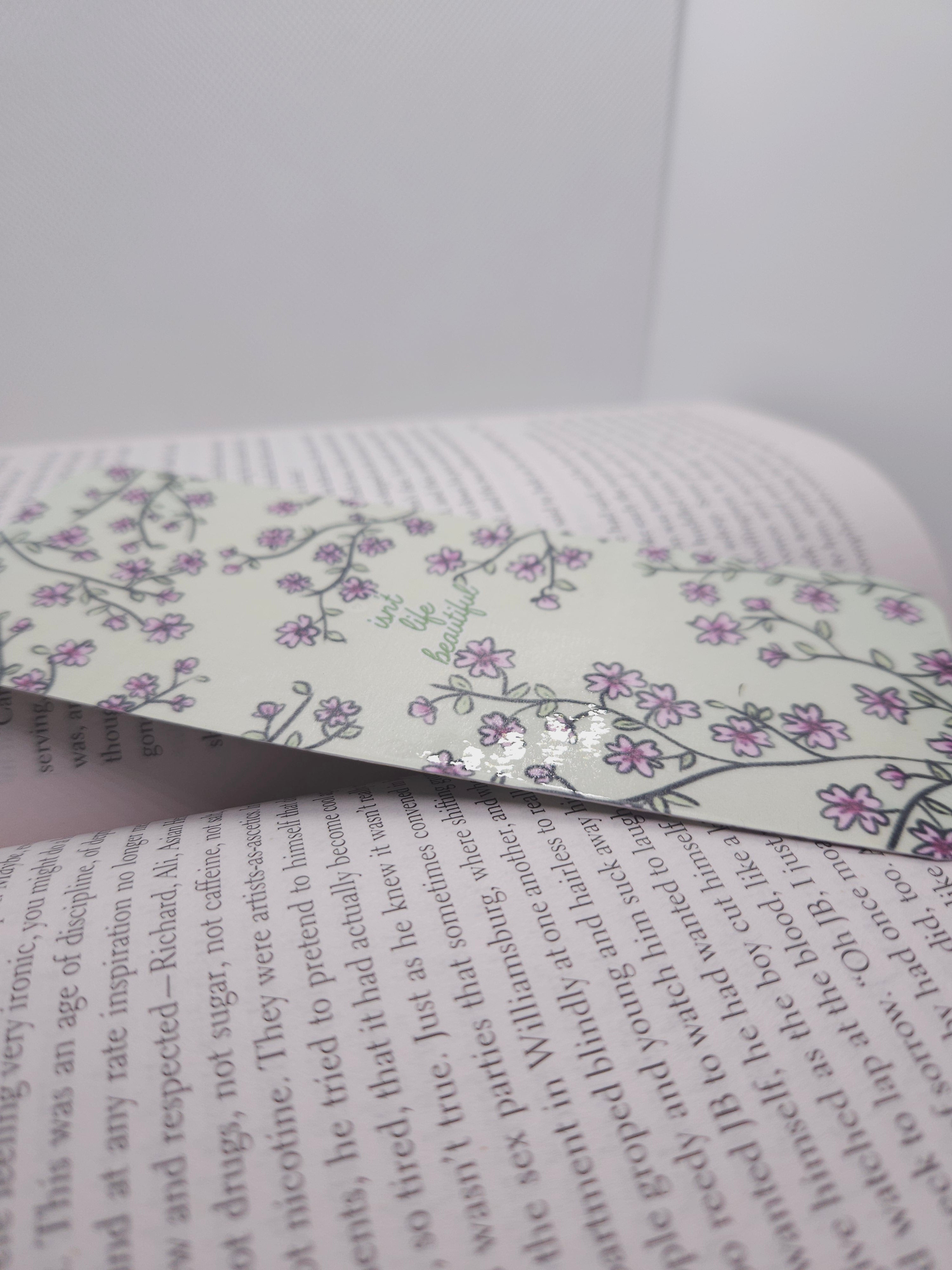 Floral bookmark on an open book with text visible