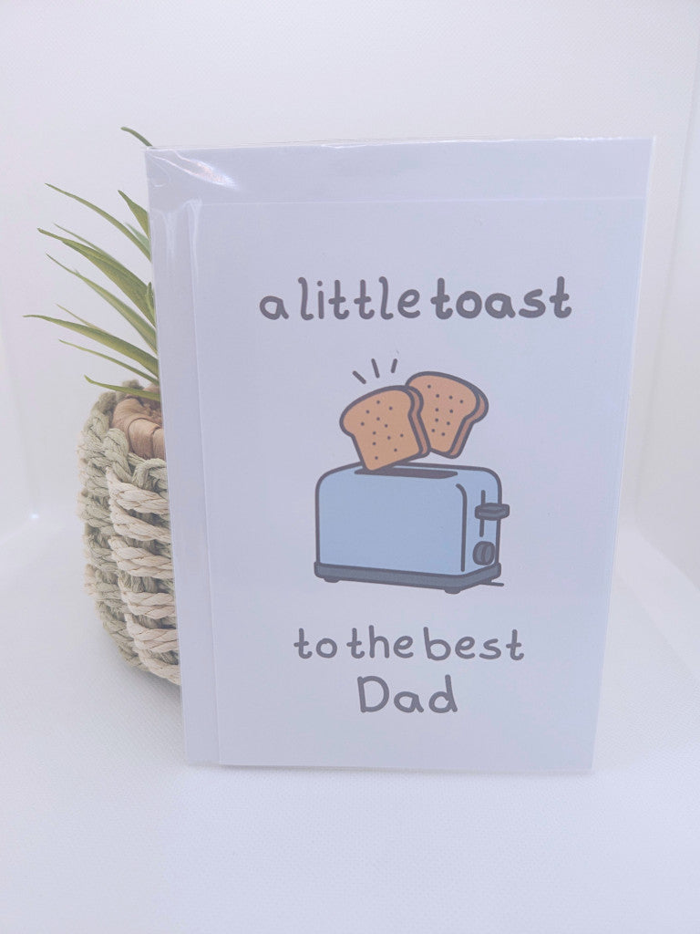 Card with toaster and toast illustration and text 'a little toast to the best Dad' on a white background.