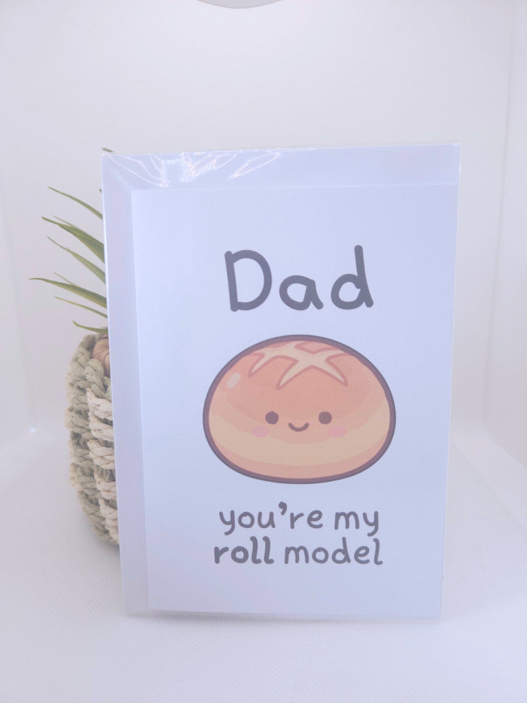 Card with a cartoon roll and text 'Dad you're my roll model' on a white background