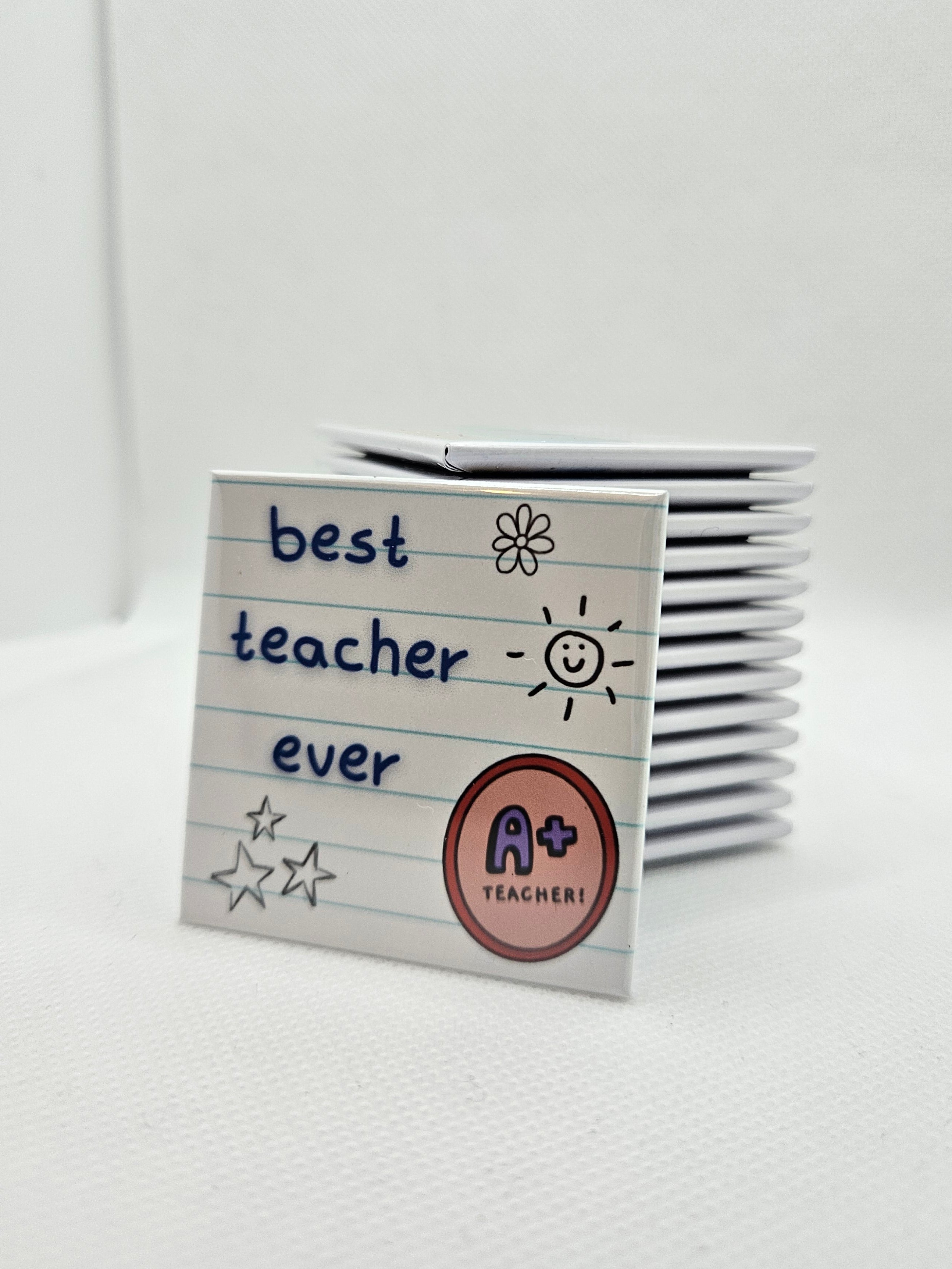 white magnet with notebook background and words best teacher ever