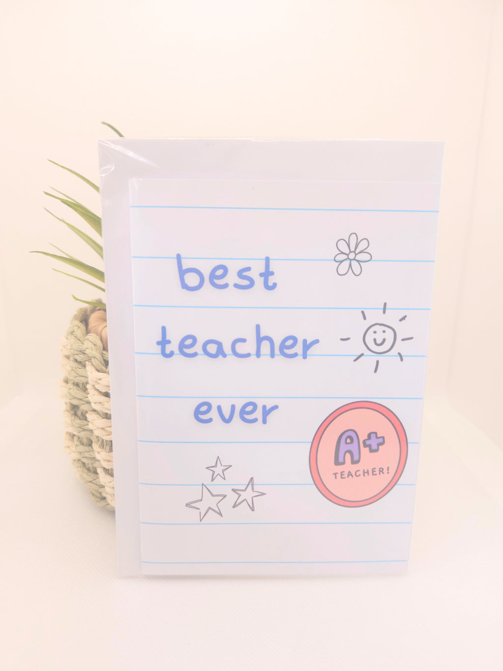 Card with 'best teacher ever' text on a notepad striped background