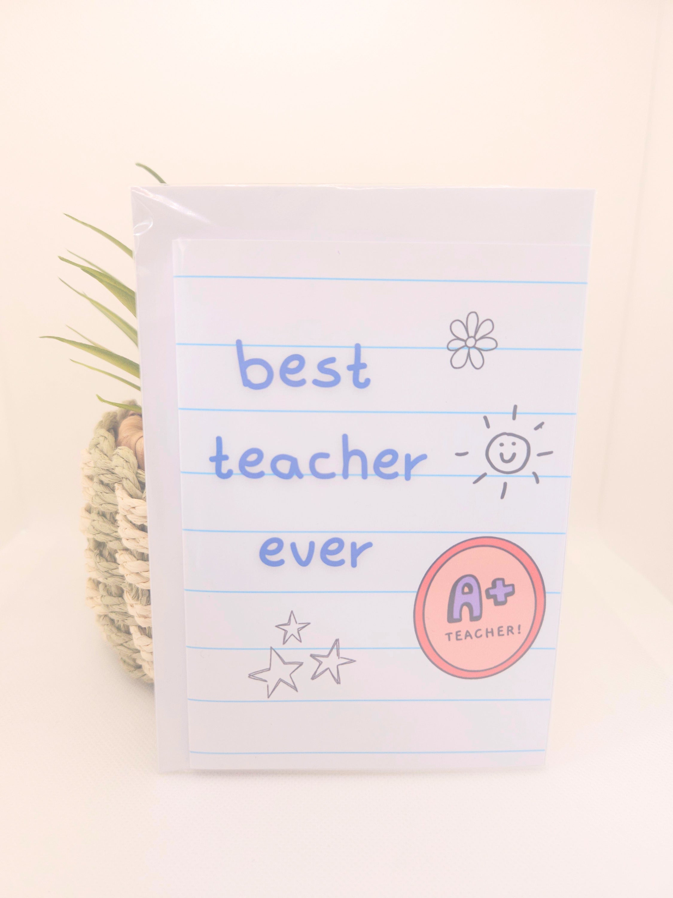 Card with 'best teacher ever' text on a notepad striped background