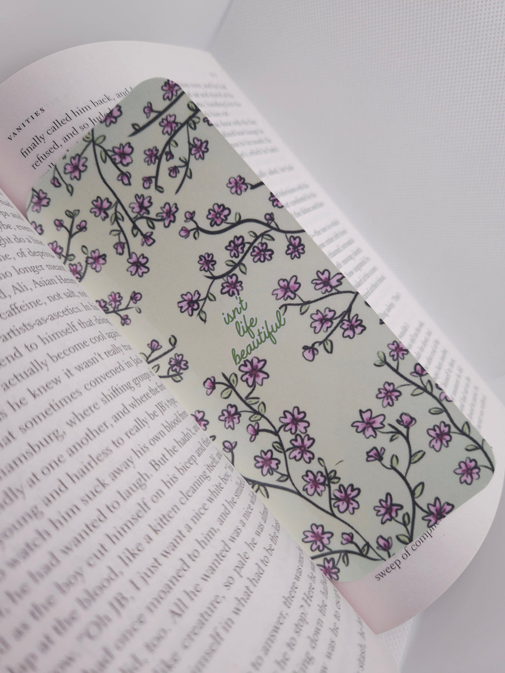 Floral patterned bookmark over a book page
