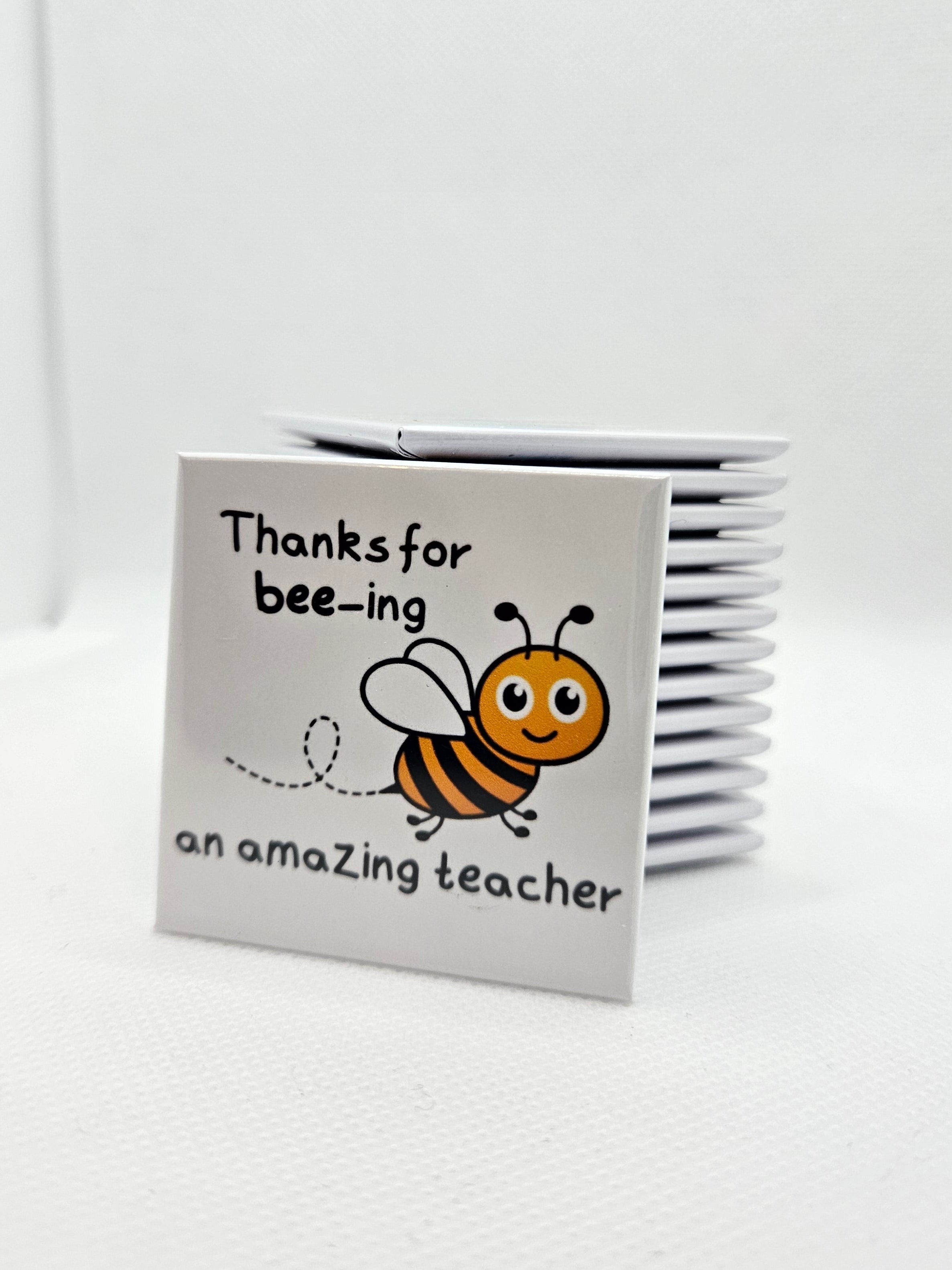 white magnet with a cartoon bee