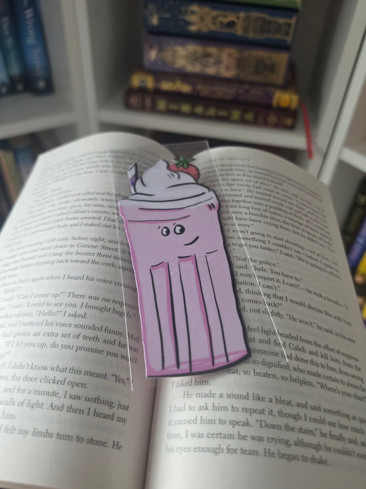 pink milkshake shaped bookmark on an open book 
