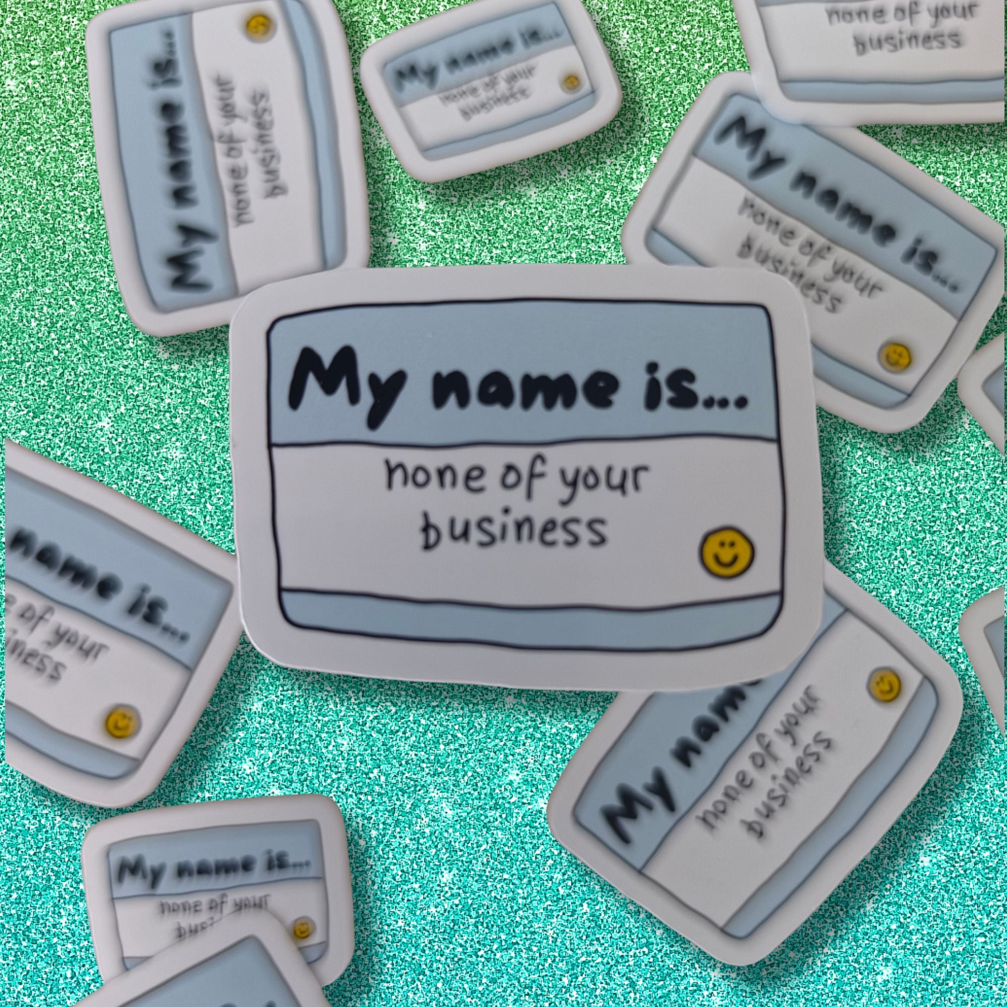 A collection of novelty name tags stickers with the text 'My name is none of your business
