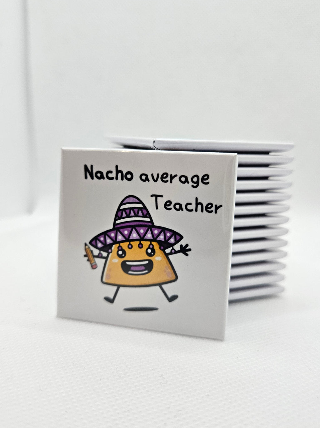 magnet with a humourous image of a nacho holding a pencil