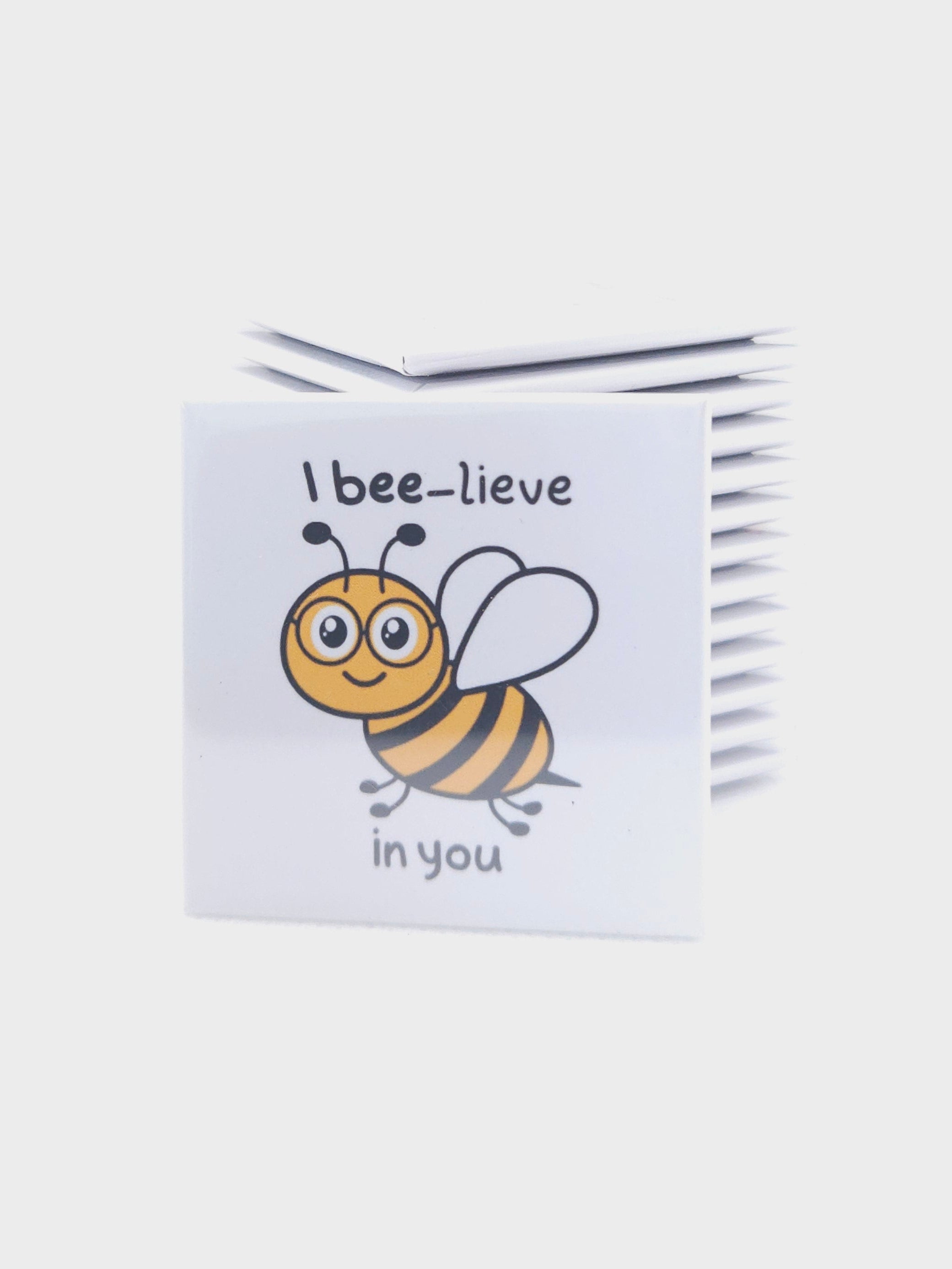 magnet with a bee illustration and 'I bee-lieve in you' text on a white background