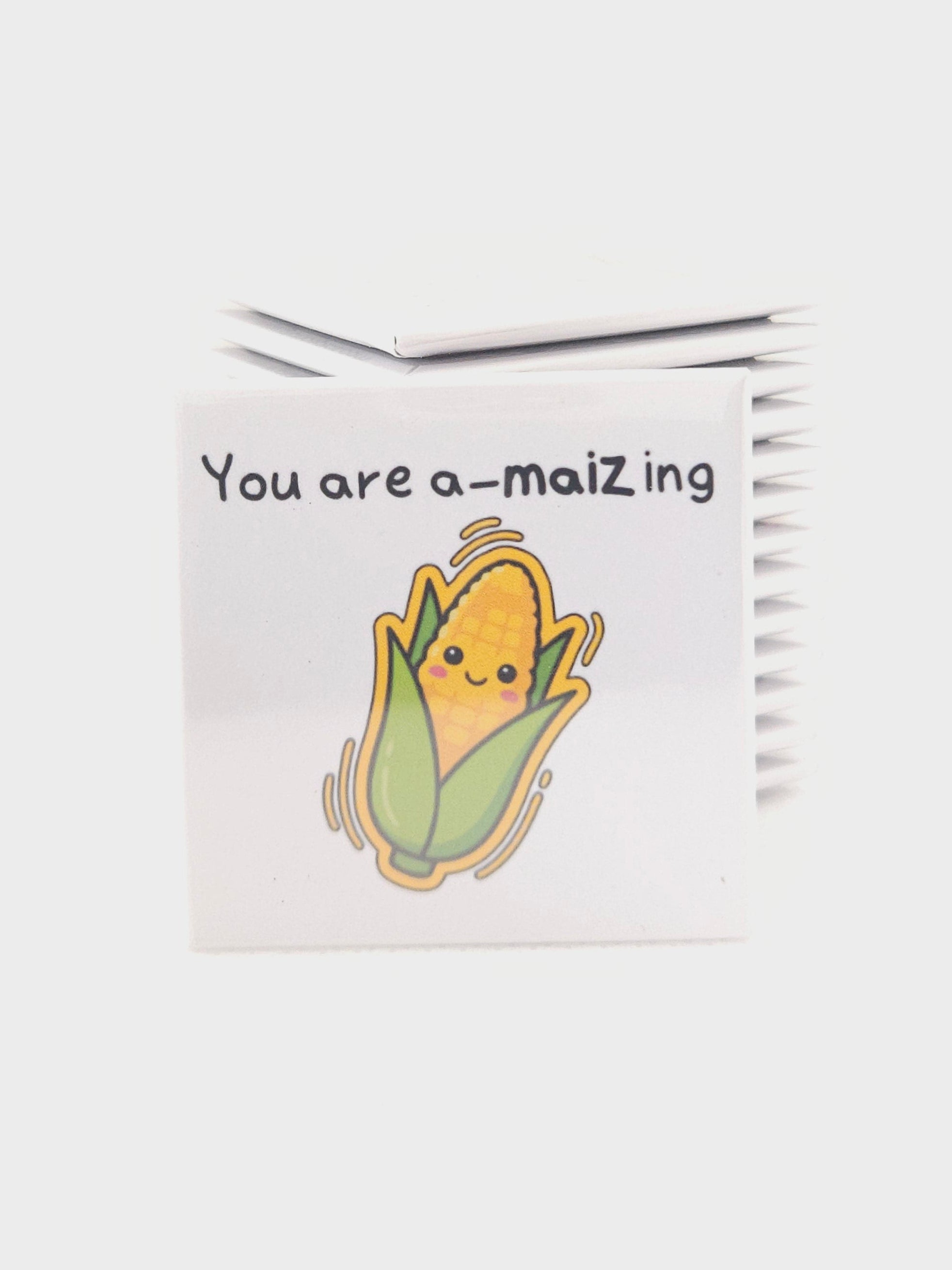 White magnet with a cartoon character and text on a white background