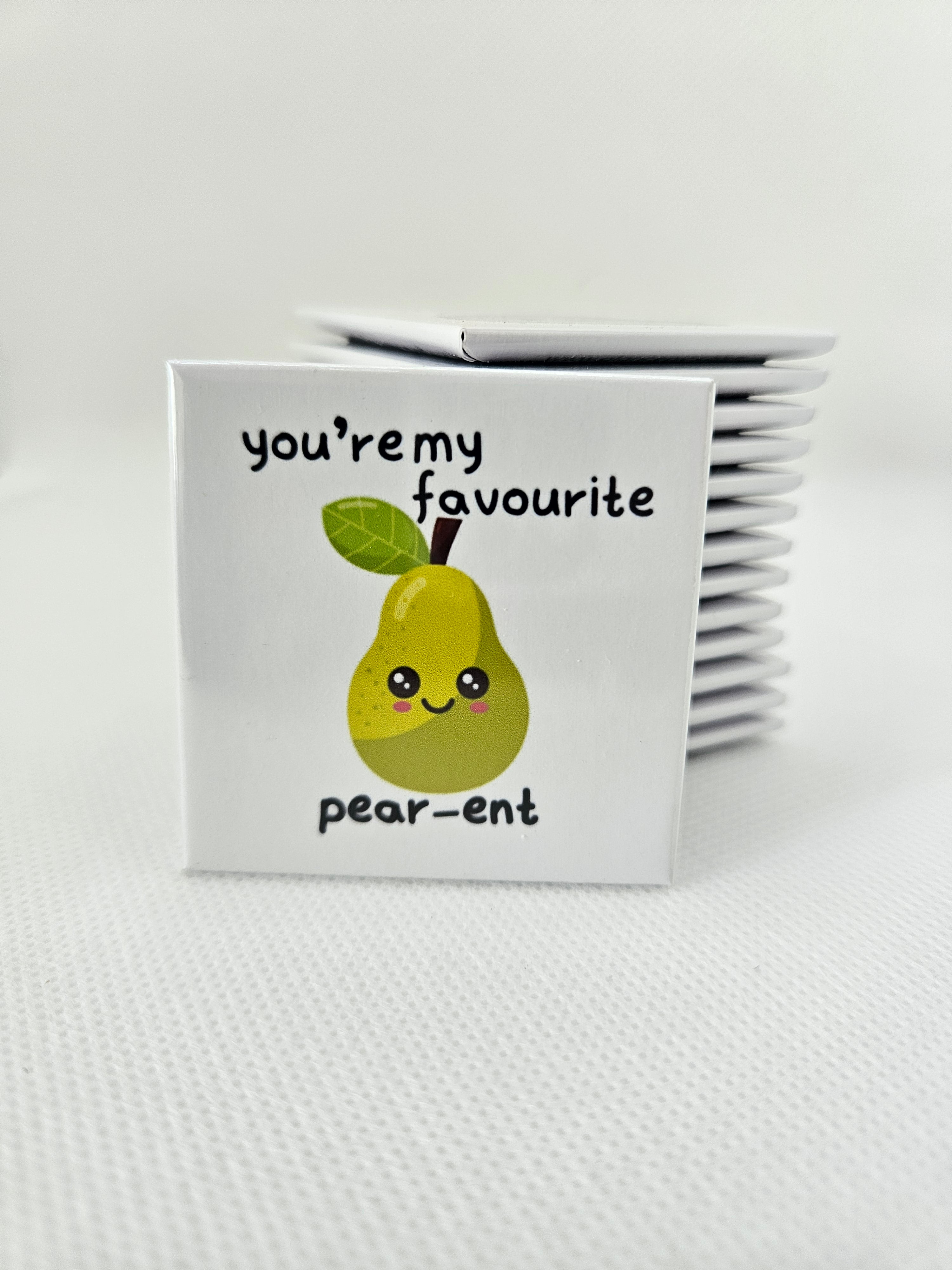 white magnet with a cartoon pear and text on a white background