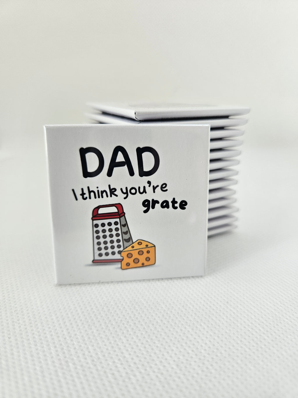 magnets with 'DAD I think you're grate' text and grater illustration on a white background