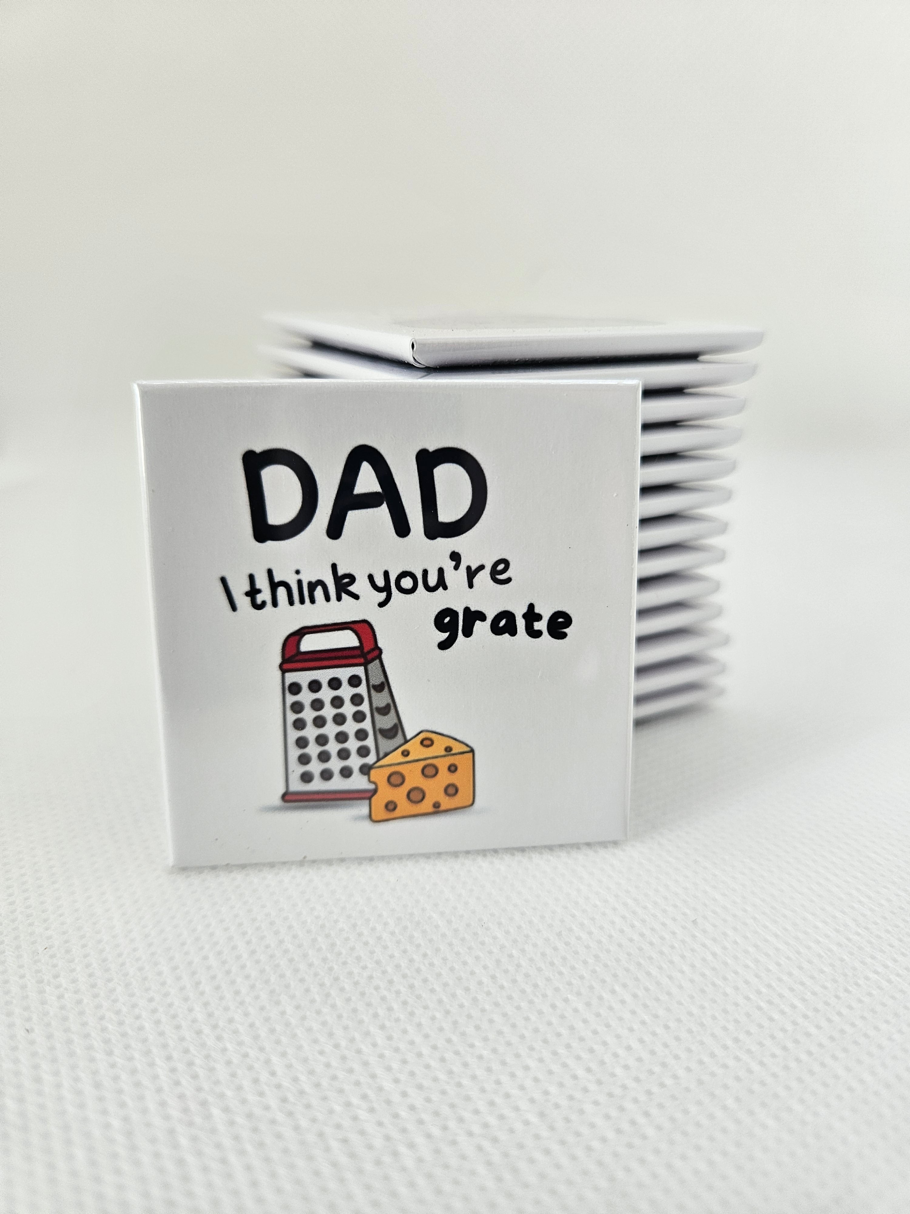 magnets with 'DAD I think you're grate' text and grater illustration on a white background