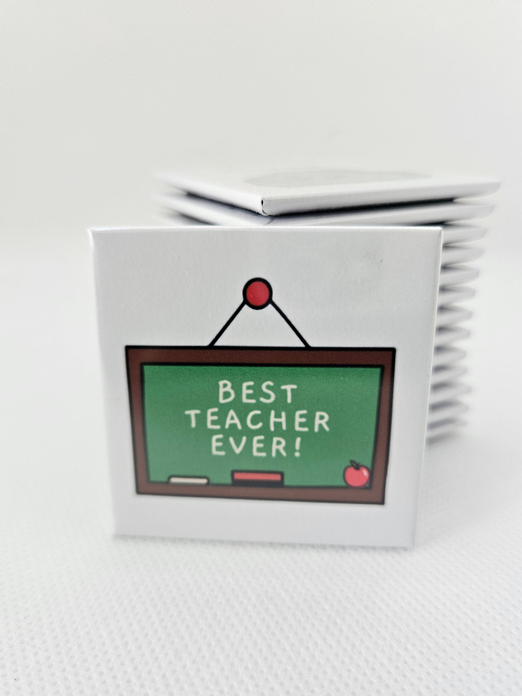 magnet with a chalkboard design and 'Best Teacher Ever!' text on a white textured surface.