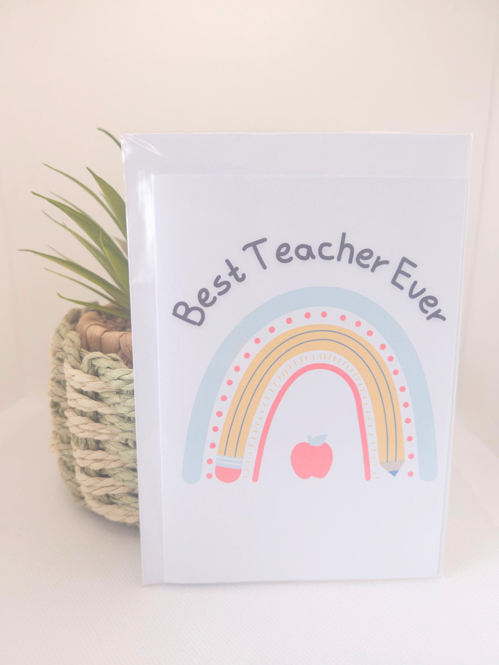 Card with rainbow design and 'Best Teacher Ever' text on a white background