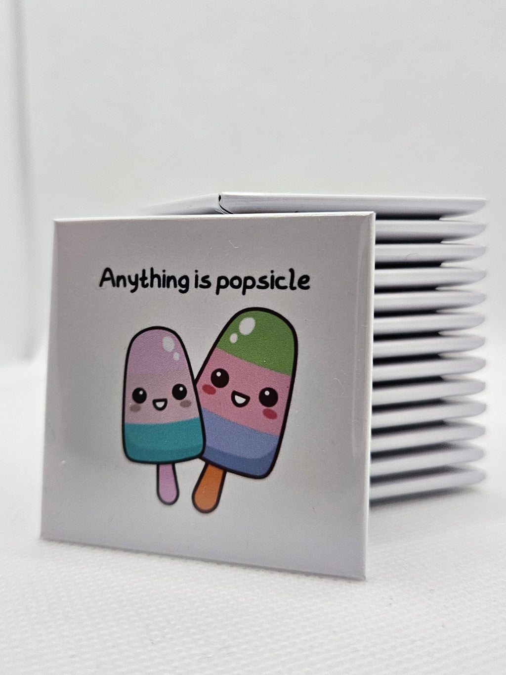 magnet with 2 coloured popsicles with cartoon eyes