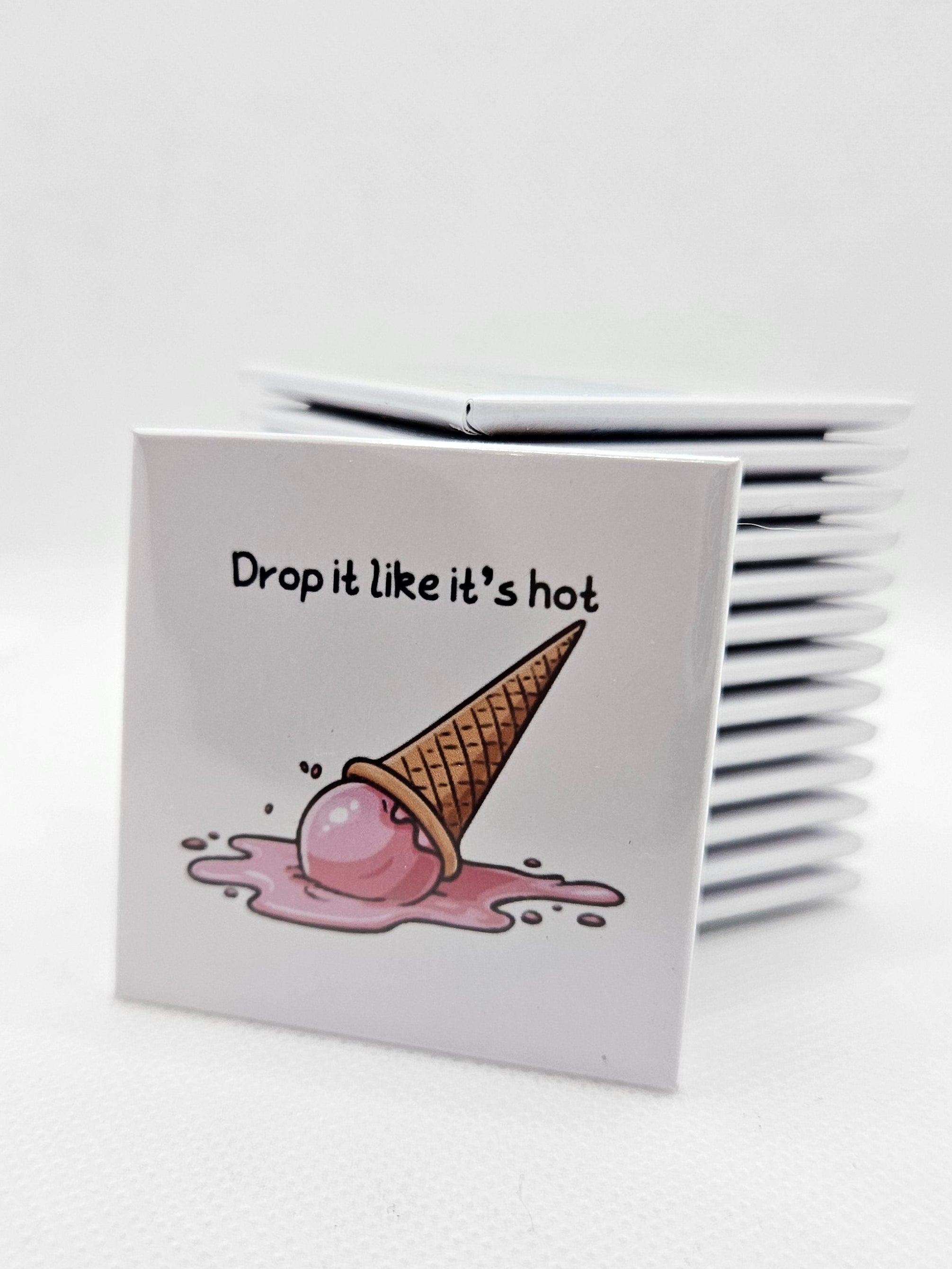 magnet with an ice cream cone dropped on the ground and melting and text on a white background