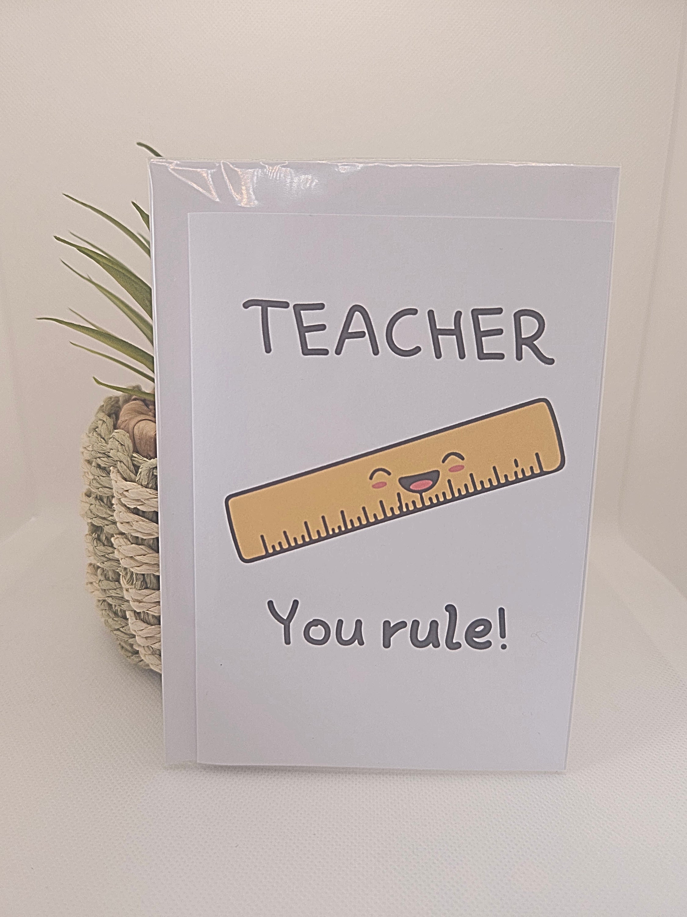 Card with a ruler illustration and 'Teacher You Rule!' text on a white background