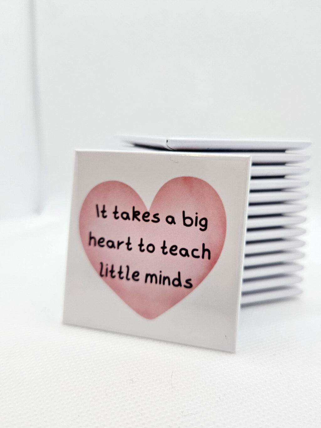 magnet with a heart design and text on a white background