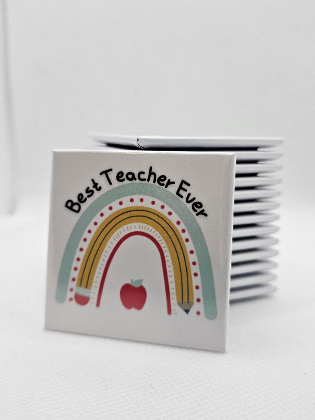 Magnet with a rainbow and apple design on a white background