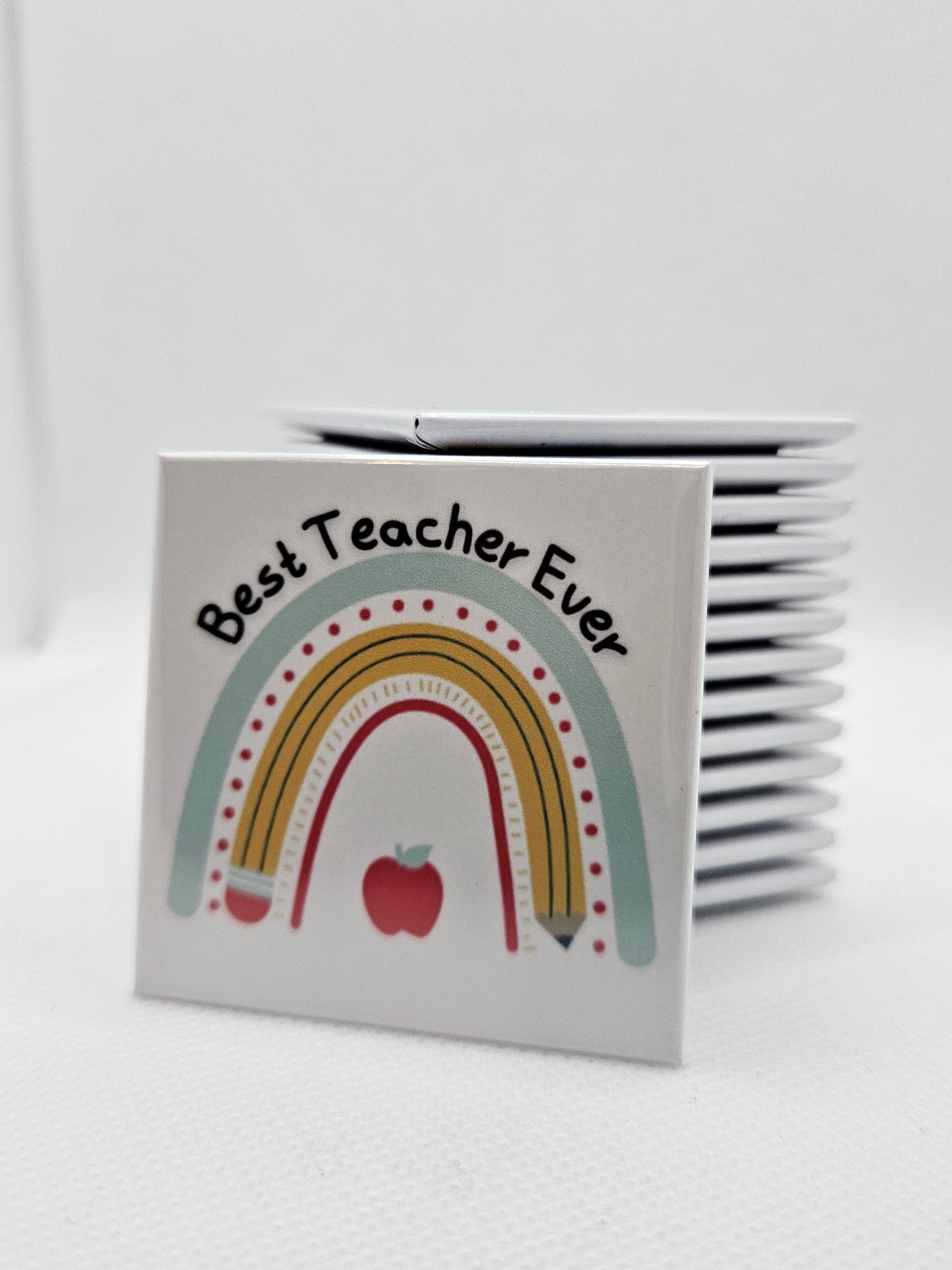 Magnet with a rainbow and apple design on a white background