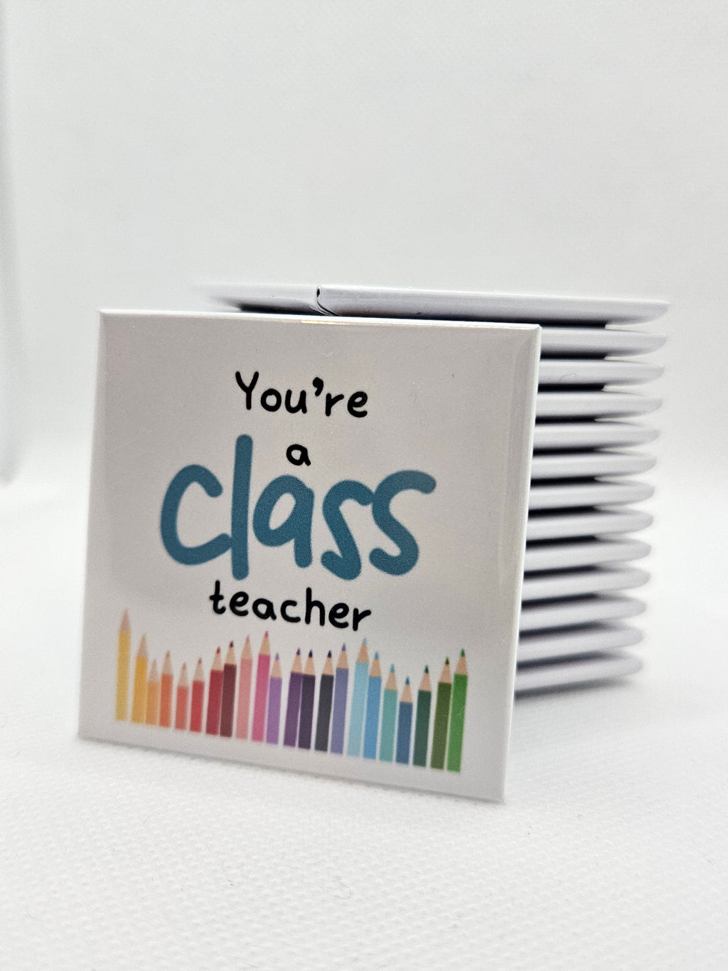magnet with colorful pencil illustrations and text on a white background