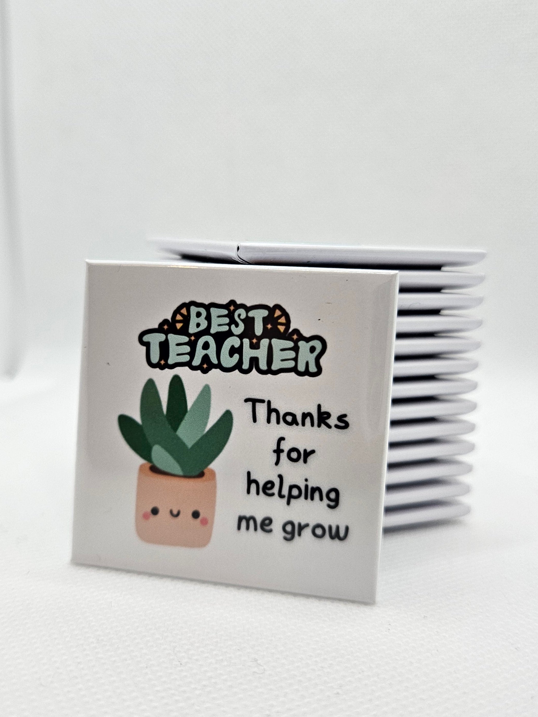 Small white magnet with a plant illustration and text on a white background