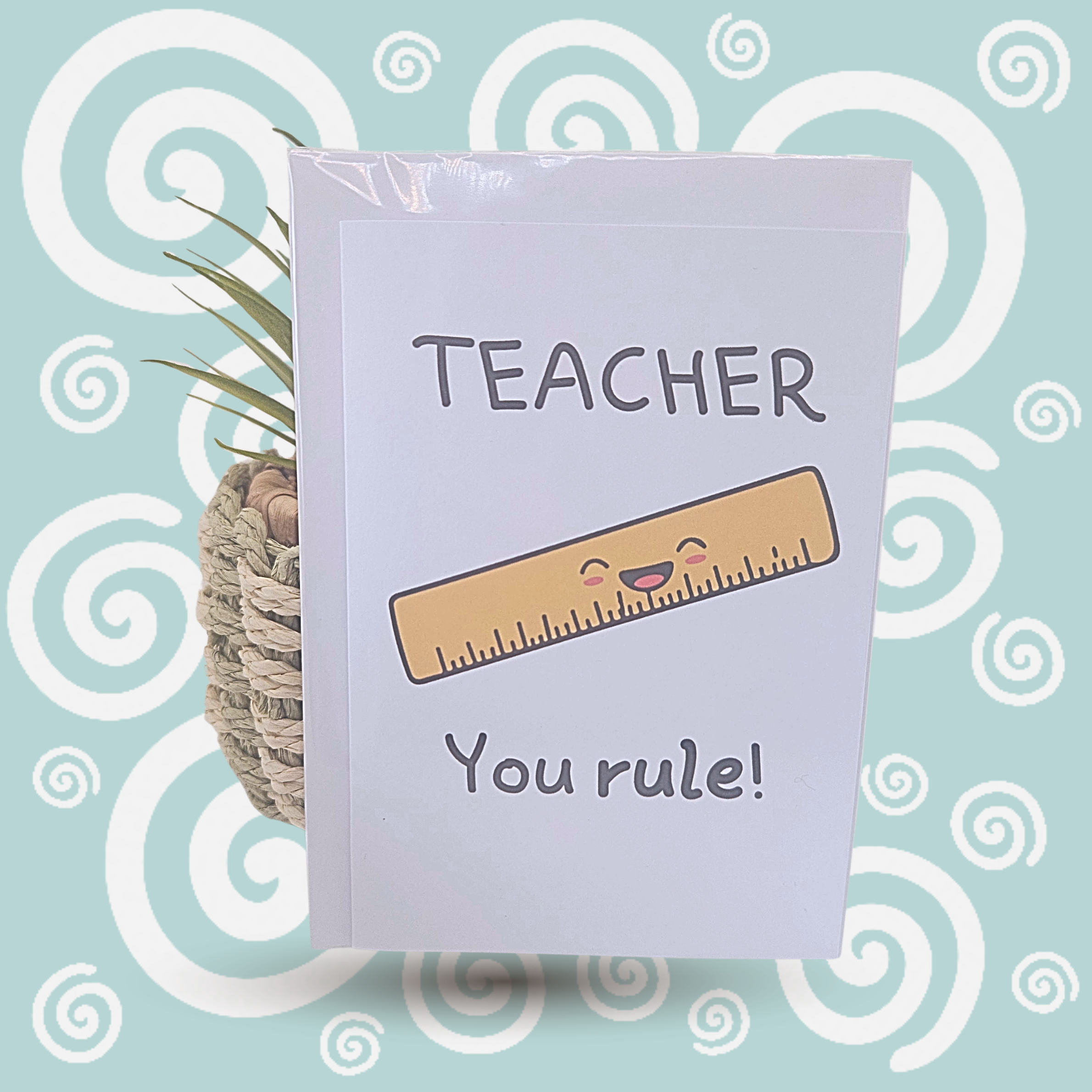 Card with a ruler illustration and text 'TEACHER You rule!' on a decorative background