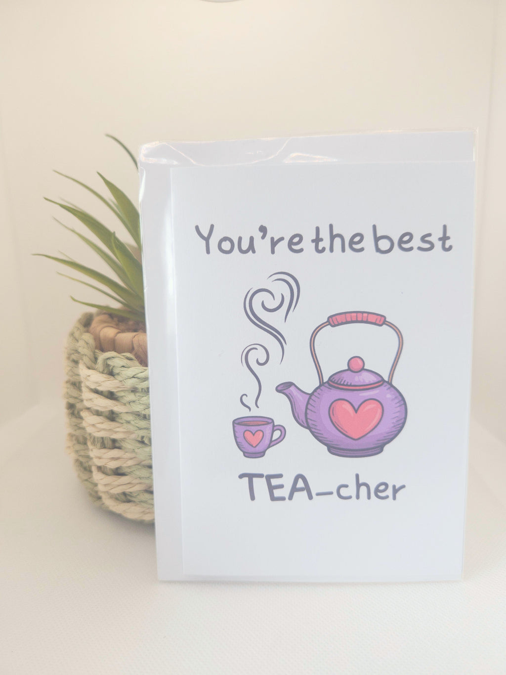 Notebook with a tea-themed design and text 'You're the best TEA-cher' on a light background.
