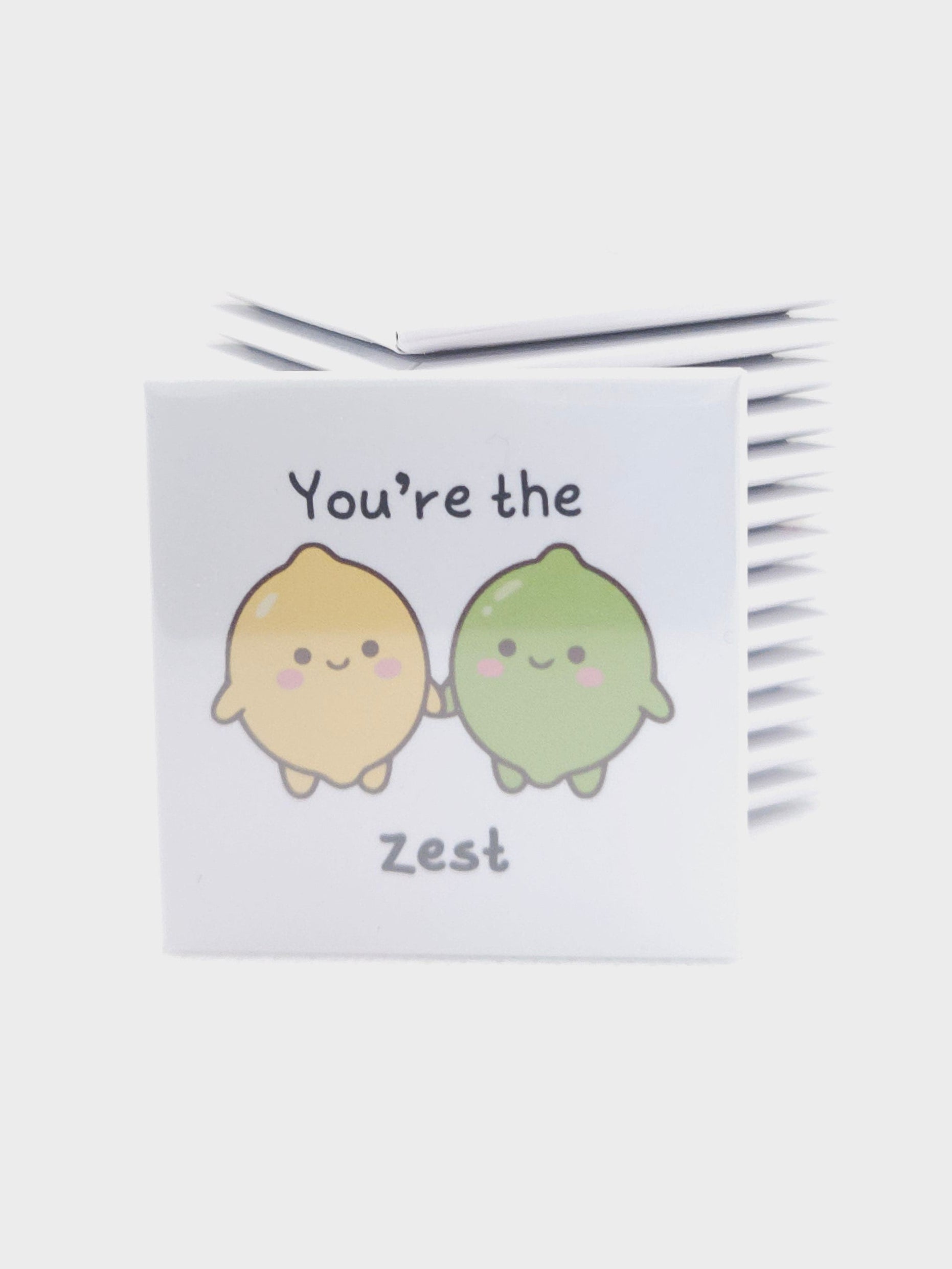 magnet with cartoon characters and text on a white background